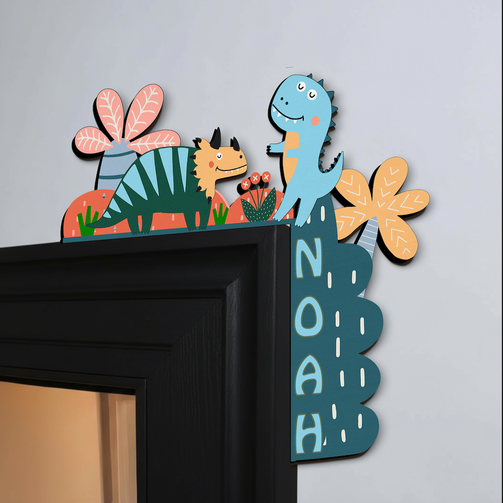 Decorative wall art with cartoon dinosaurs and flowers on a fireplace mantle.