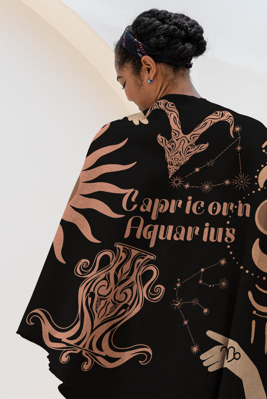 Woven tapestry throw blanket featuring the Aquarius and Capricorn zodiac symbols. Perfect for astrology enthusiasts, this cotton throw blanket adds a touch of boho style and celestial charm to your home decor.