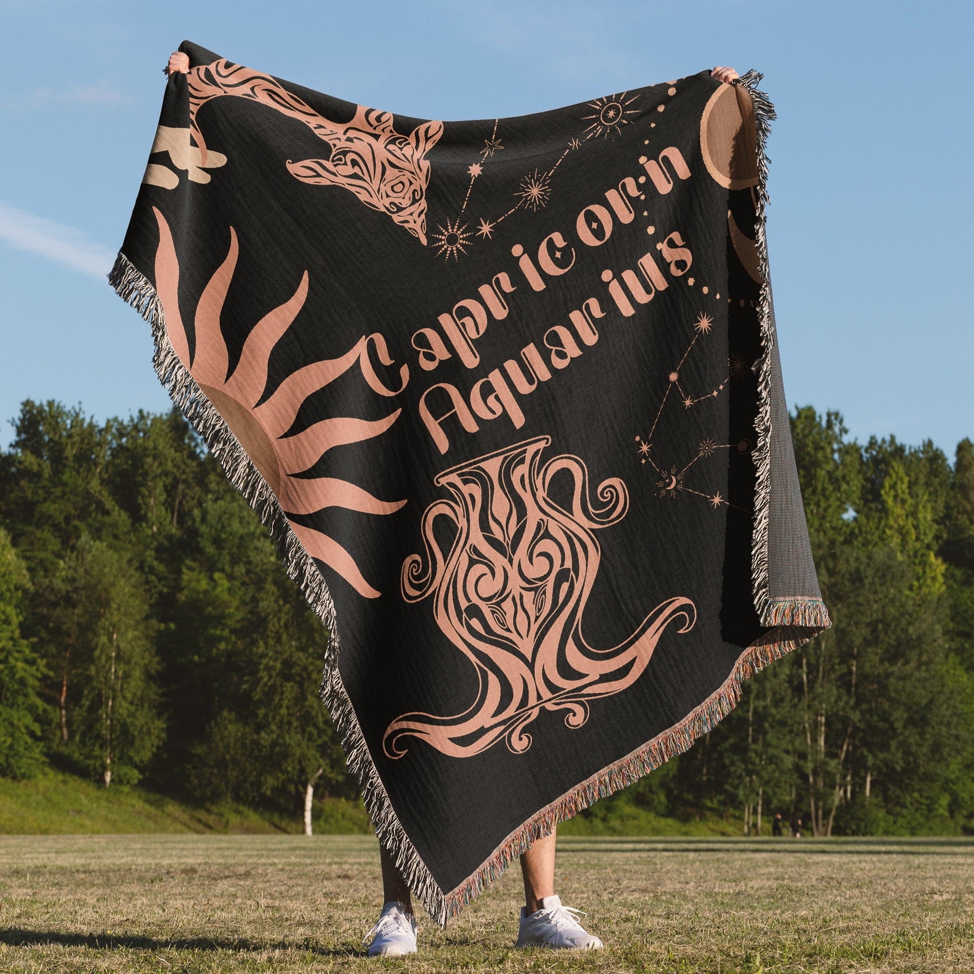 Woven tapestry throw blanket featuring the Aquarius and Capricorn zodiac symbols. Perfect for astrology enthusiasts, this cotton throw blanket adds a touch of boho style and celestial charm to your home decor.