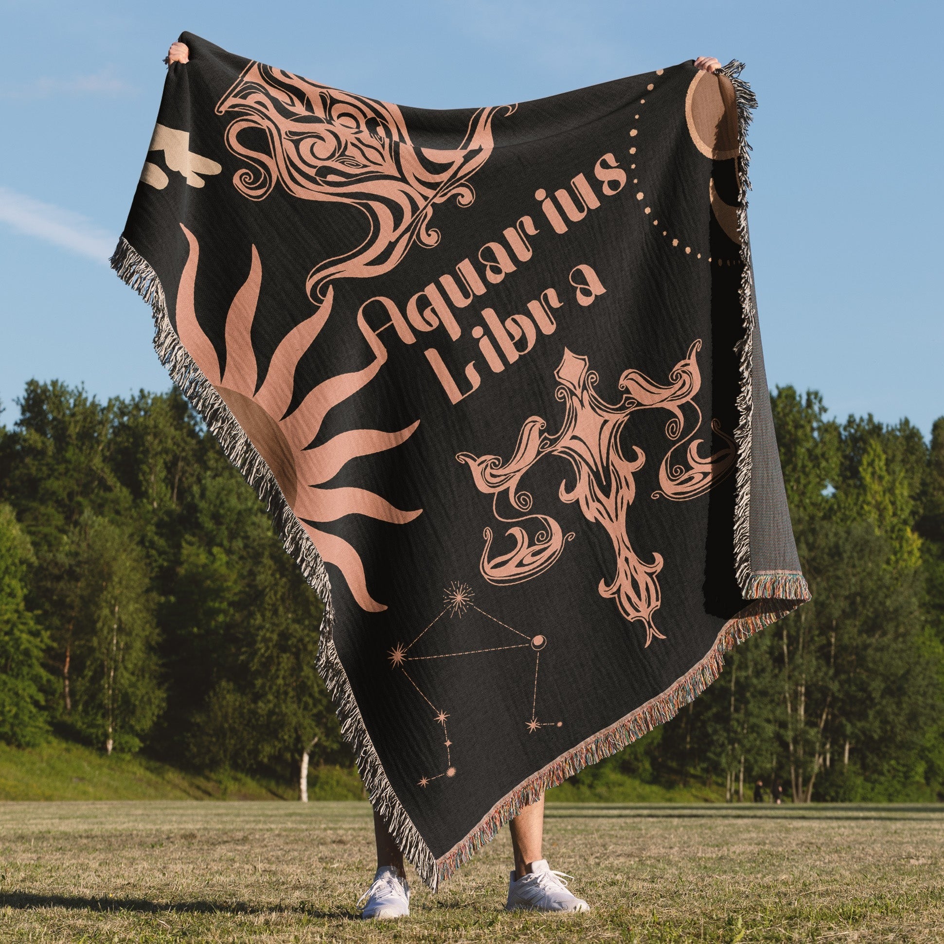 Woven tapestry throw blanket featuring the Aquarius and Libra zodiac symbols. Perfect for astrology enthusiasts, this cotton throw blanket adds a touch of boho style and celestial charm to your home decor.
