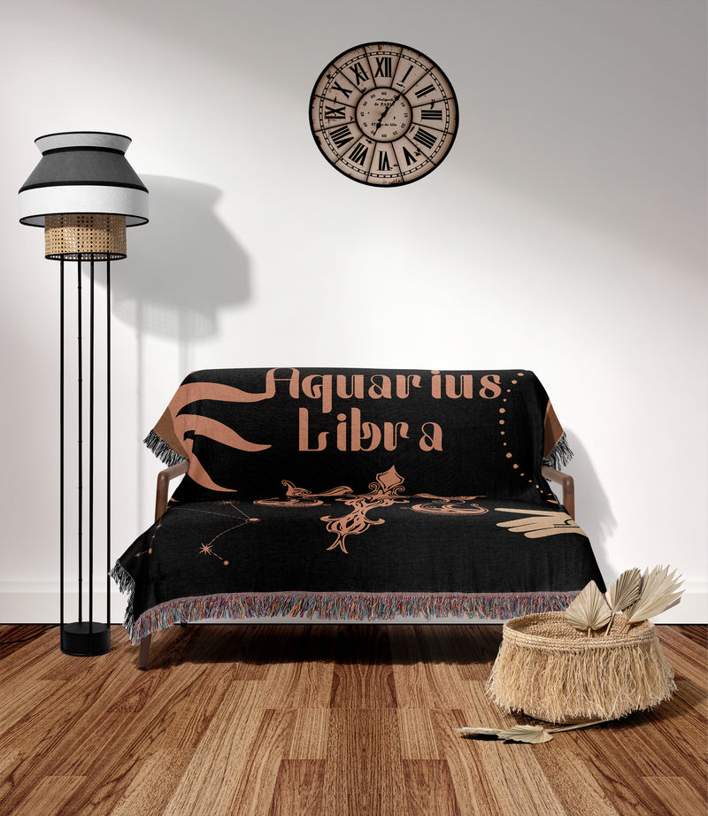 Woven tapestry throw blanket featuring the Aquarius and Libra zodiac symbols. Perfect for astrology enthusiasts, this cotton throw blanket adds a touch of boho style and celestial charm to your home decor.