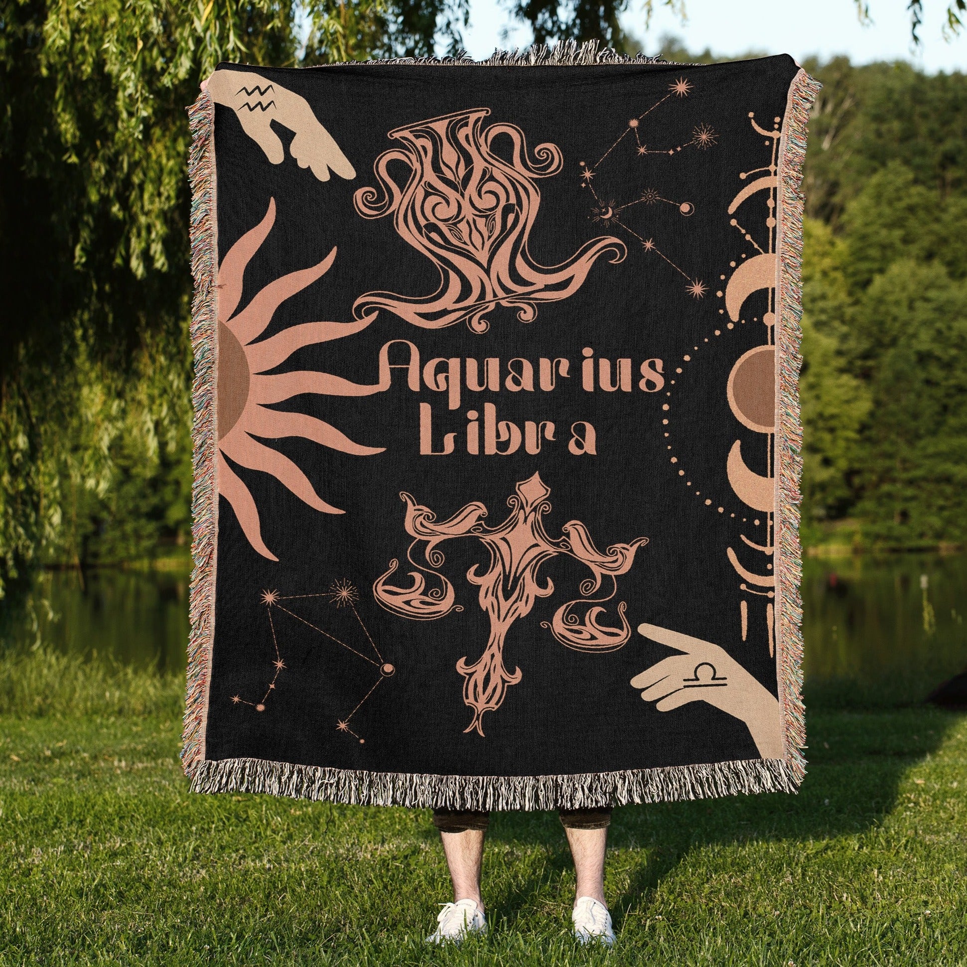 Woven tapestry throw blanket featuring the Aquarius and Libra zodiac symbols. Perfect for astrology enthusiasts, this cotton throw blanket adds a touch of boho style and celestial charm to your home decor.