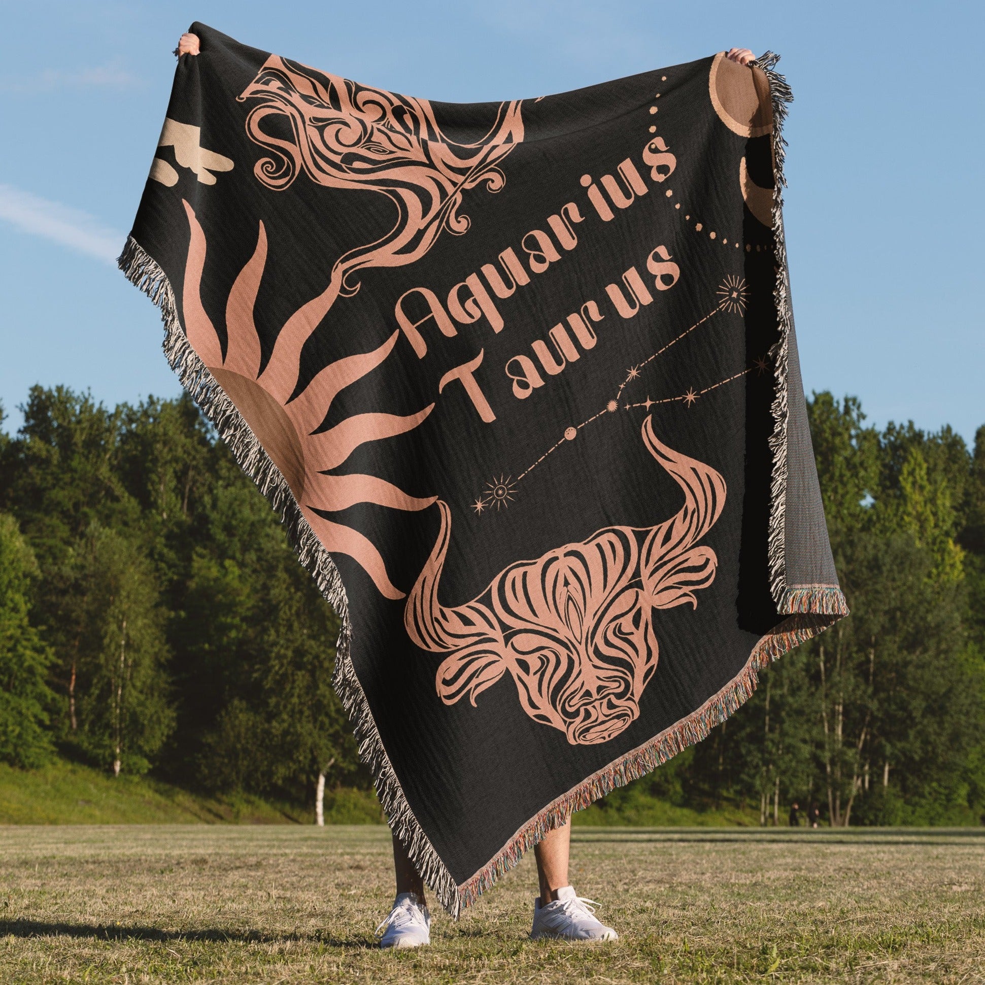 Woven tapestry throw blanket featuring the Aquarius and Taurus zodiac symbols. Perfect for astrology enthusiasts, this cotton throw blanket adds a touch of boho style and celestial charm to your home decor.