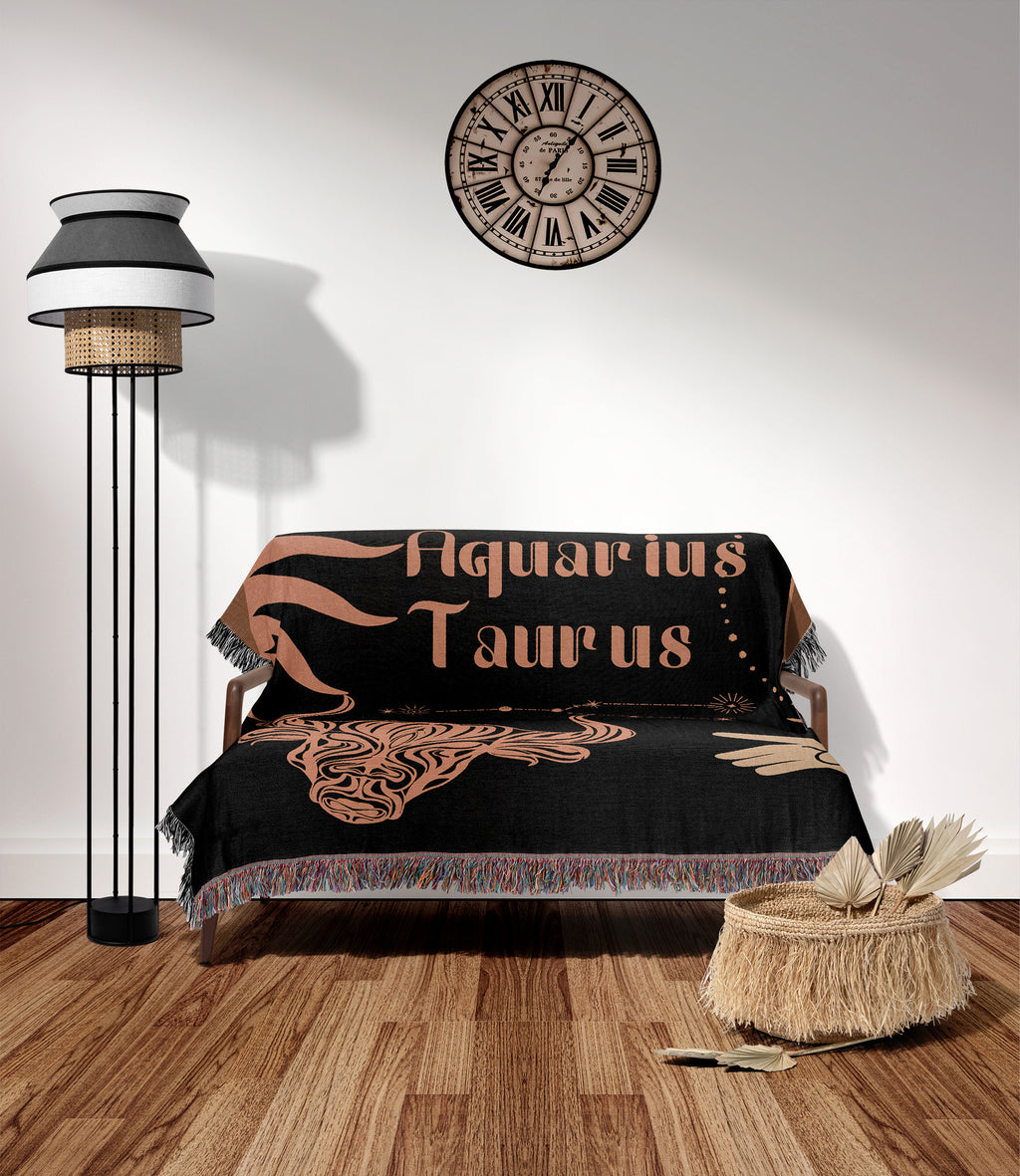 Woven tapestry throw blanket featuring the Aquarius and Taurus zodiac symbols. Perfect for astrology enthusiasts, this cotton throw blanket adds a touch of boho style and celestial charm to your home decor.