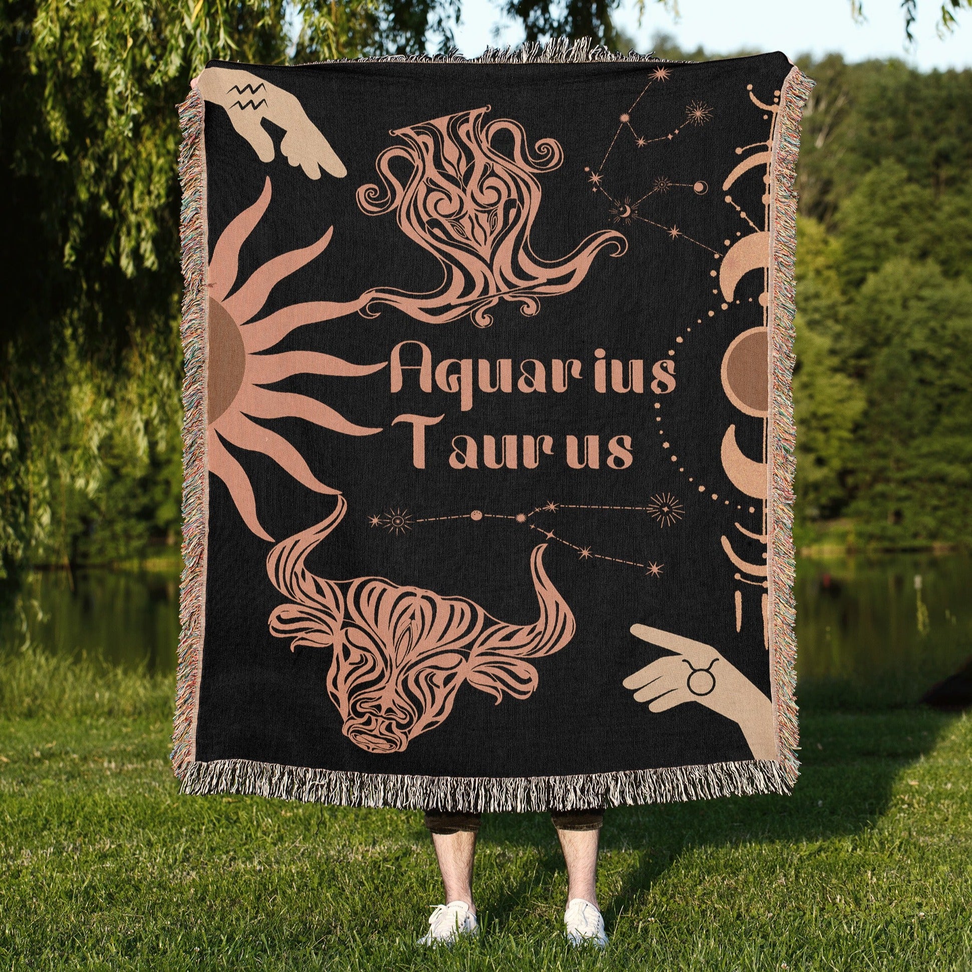 Woven tapestry throw blanket featuring the Aquarius and Taurus zodiac symbols. Perfect for astrology enthusiasts, this cotton throw blanket adds a touch of boho style and celestial charm to your home decor.