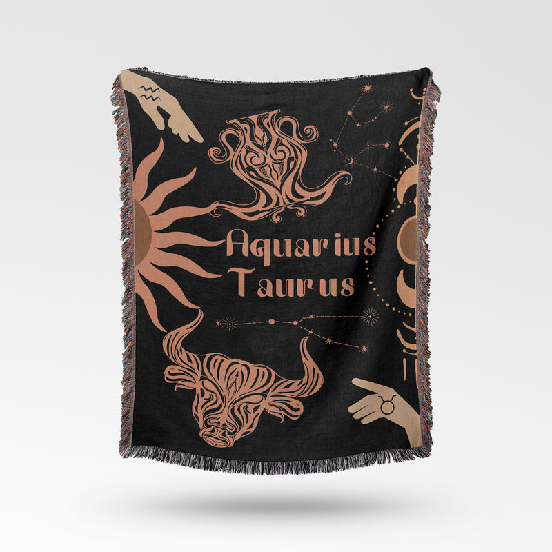 Woven tapestry throw blanket featuring the Aquarius and Taurus zodiac symbols. Perfect for astrology enthusiasts, this cotton throw blanket adds a touch of boho style and celestial charm to your home decor.