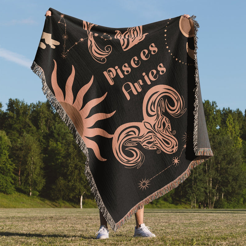 Woven tapestry throw blanket featuring the Aries and Pisces zodiac symbols. Perfect for astrology enthusiasts, this cotton throw blanket adds a touch of boho style and celestial charm to your home decor.