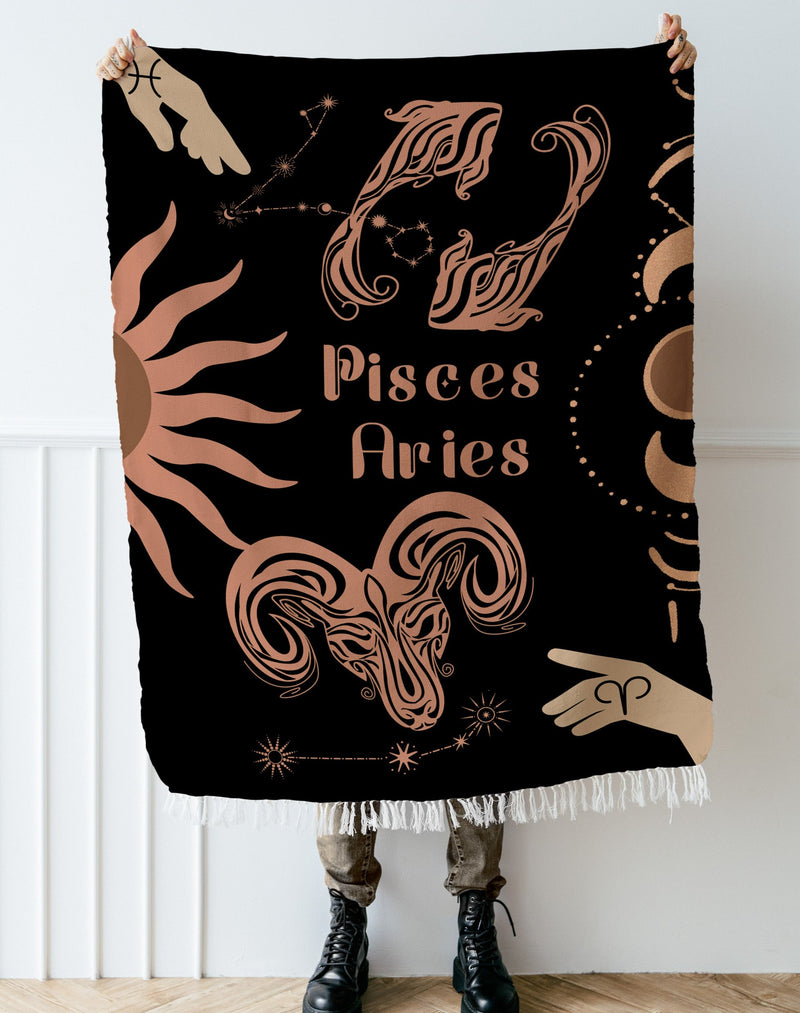 Woven tapestry throw blanket featuring the Aries and Pisces zodiac symbols. Perfect for astrology enthusiasts, this cotton throw blanket adds a touch of boho style and celestial charm to your home decor.