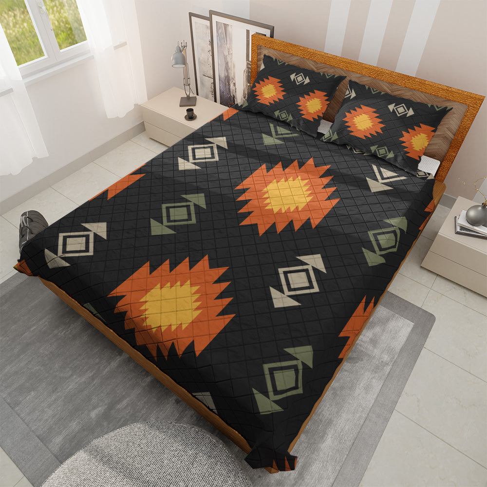 Black Southwestern quilted bedspread set with orange sunbursts in a bright bedroom