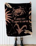 Cancer and Capricorn Zodiac Compatibility Woven Throw Tapestry - Elevate home decor with this boho-inspired, celestial charm blanket. Perfect for astrology enthusiasts, featuring Aries and Scorpio sun signs, adding unique, artistic flair to your living space. Premium cotton, cozy, and decorative.