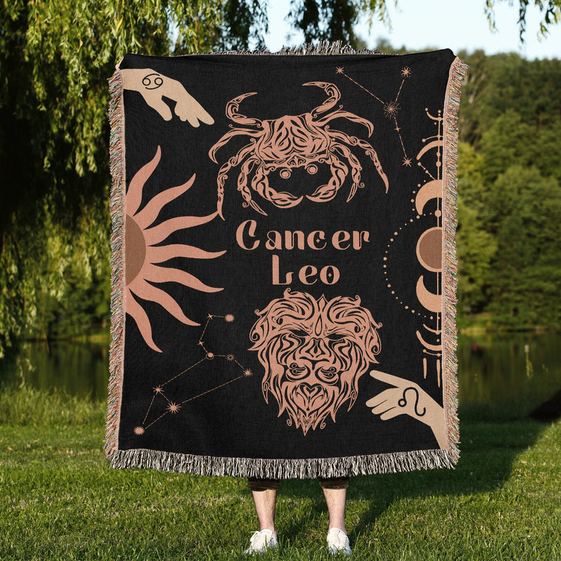 Cancer and Leo Zodiac Compatibility Woven Throw Tapestry - Elevate home decor with this boho-inspired, celestial charm blanket. Perfect for astrology enthusiasts, featuring Aries and Scorpio sun signs, adding unique, artistic flair to your living space. Premium cotton, cozy, and decorative.