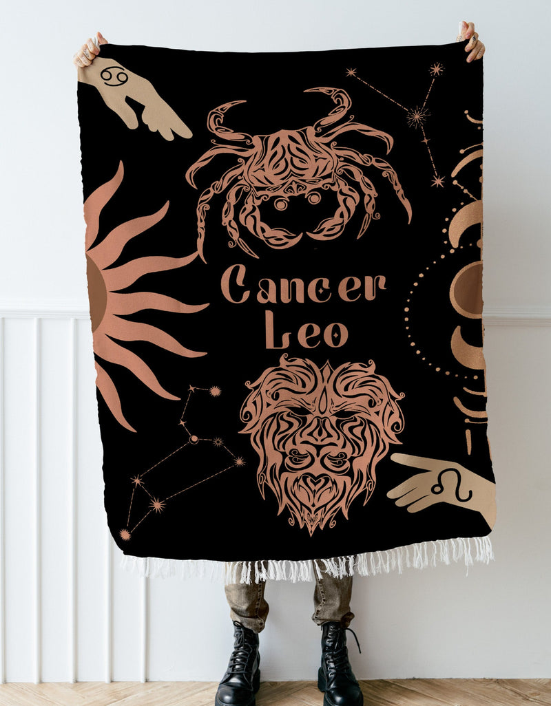 Cancer and Leo Zodiac Compatibility Woven Throw Tapestry - Elevate home decor with this boho-inspired, celestial charm blanket. Perfect for astrology enthusiasts, featuring Aries and Scorpio sun signs, adding unique, artistic flair to your living space. Premium cotton, cozy, and decorative.