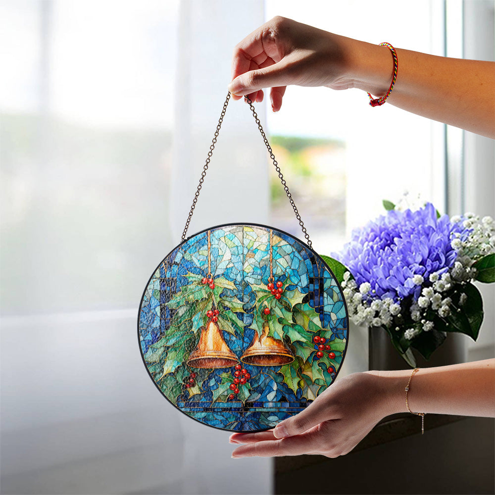 Christmas stained glass suncatcher with bells displayed near a bright window