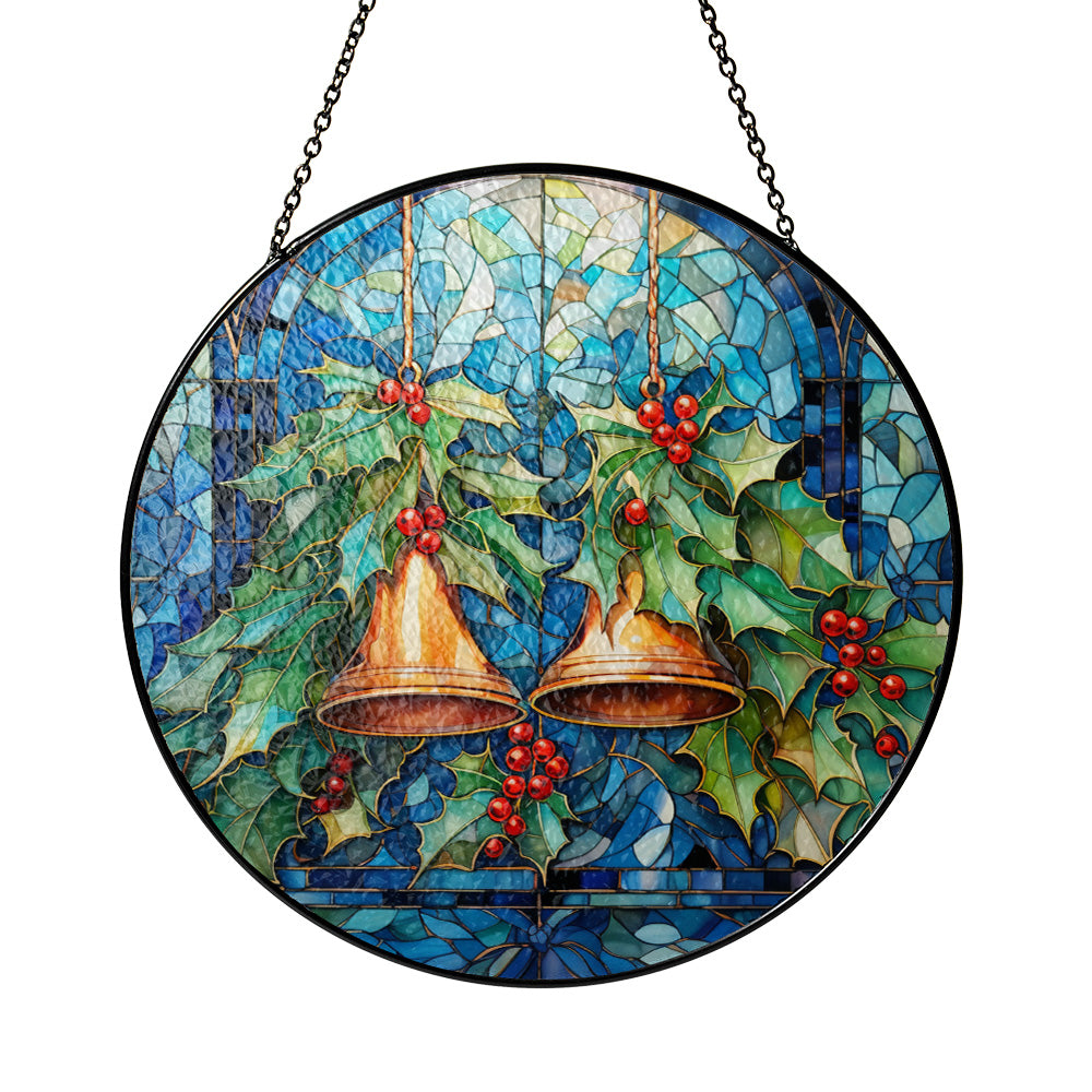 Round stained-glass style hanging ornament featuring two gold bells, green holly leaves, and red berries on a blue mosaic background, suspended by a black chain. 
