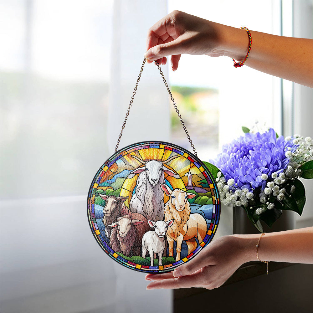 Christian sheep and lambs glass suncatcher displayed near a window
