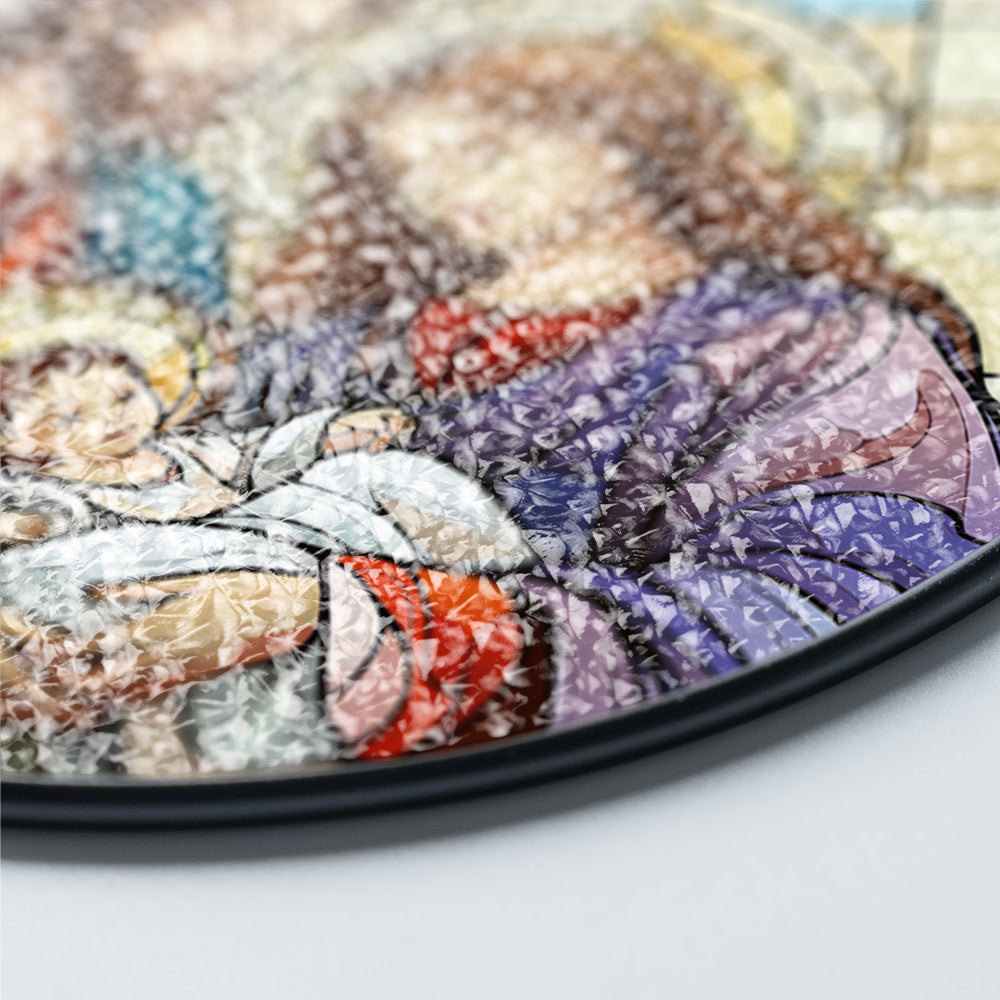 Close-up of a circular decorative art piece with a mosaic, textured pattern in purple, beige, brown, and red tones, Close-up of Holy Family Nativity stained glass suncatcher artwork