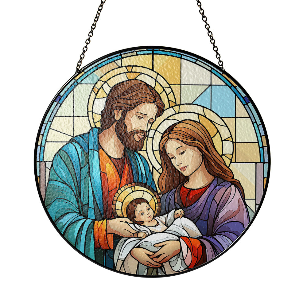 A circular stained-glass-style hanging panel showing the Holy Family: Jesus in the center, with Mary on the right in purple and Joseph on the left in blue, all framed by a black border and suspended by two chains against a plain white background. Holy Family Nativity stained glass suncatcher with Mary Joseph and baby Jesus