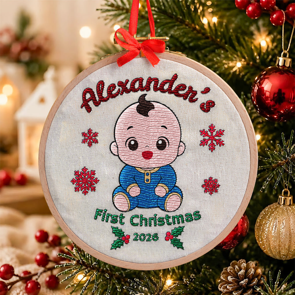 Personalized baby first Christmas embroidered hoop ornament showing smiling baby, red snowflakes and holly with red ribbon hanger