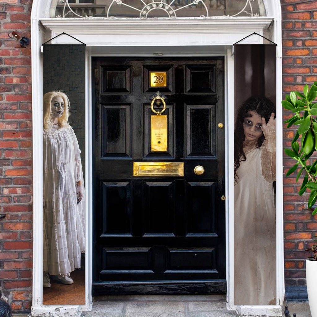 Women in White ghost Halloween door banners beside a front entrance