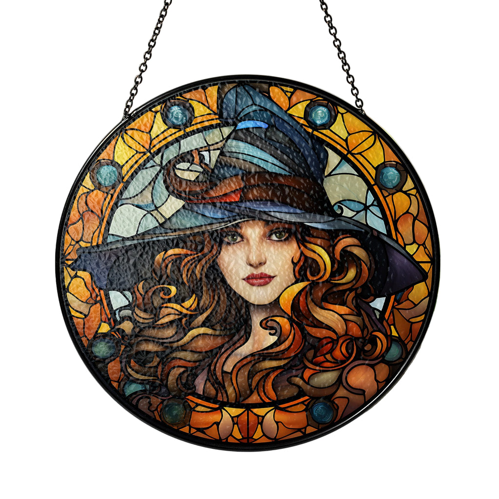 Decorative stained glass panel of a witch with long hair and a hat, hanging indoors.