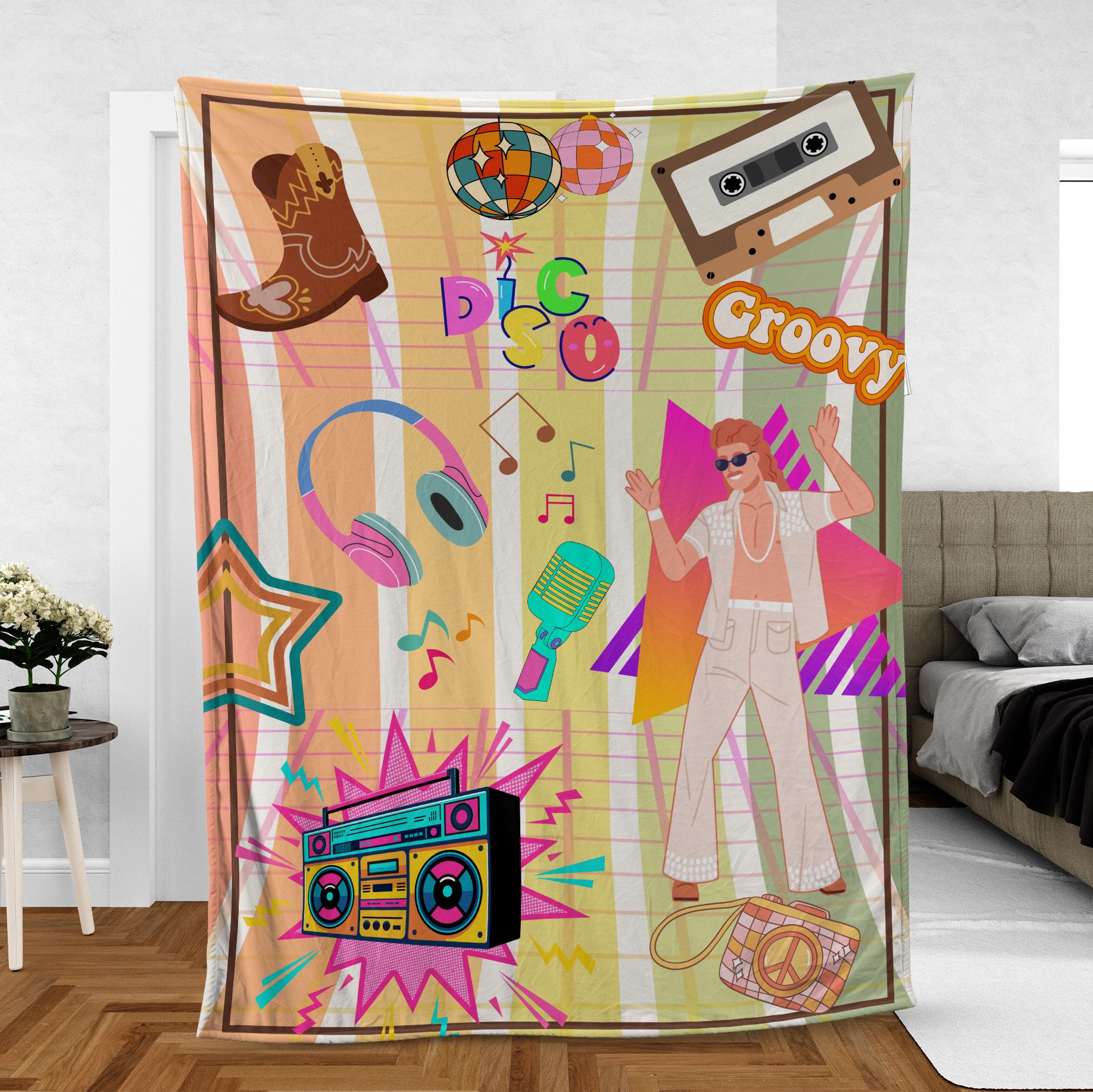 A colorful fleece blanket with a vibrant print featuring a cartoon of a man dancing, along with musical and disco-themed graphics, hung on a wall in a room.