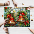 A rectangular jigsaw puzzle featuring a stained glass art design with Christmas bells, being assembled by people with a decorative background.