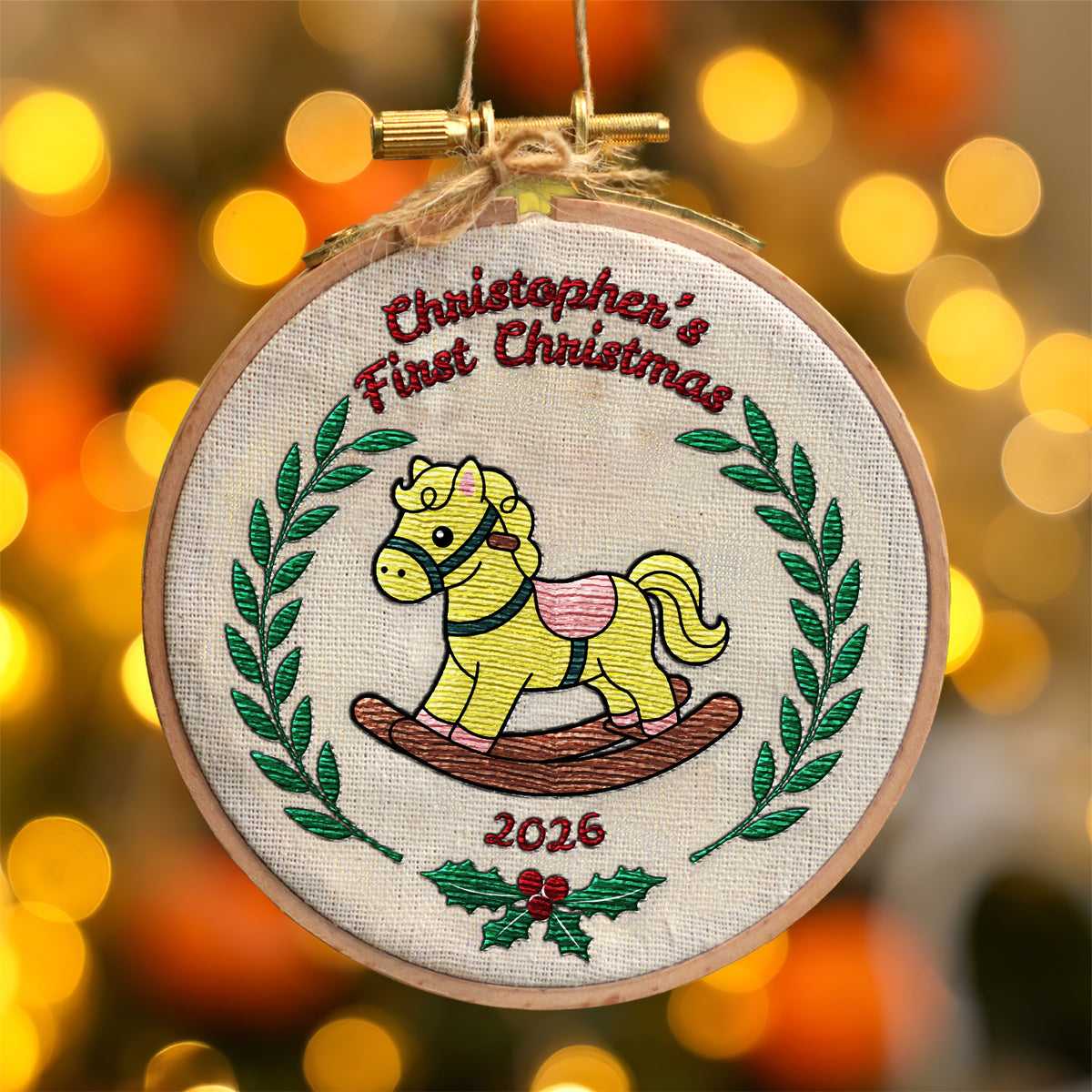 Personalized first Christmas embroidered hoop ornament featuring vintage rocking horse and green laurel wreath with natural jute twine hanger