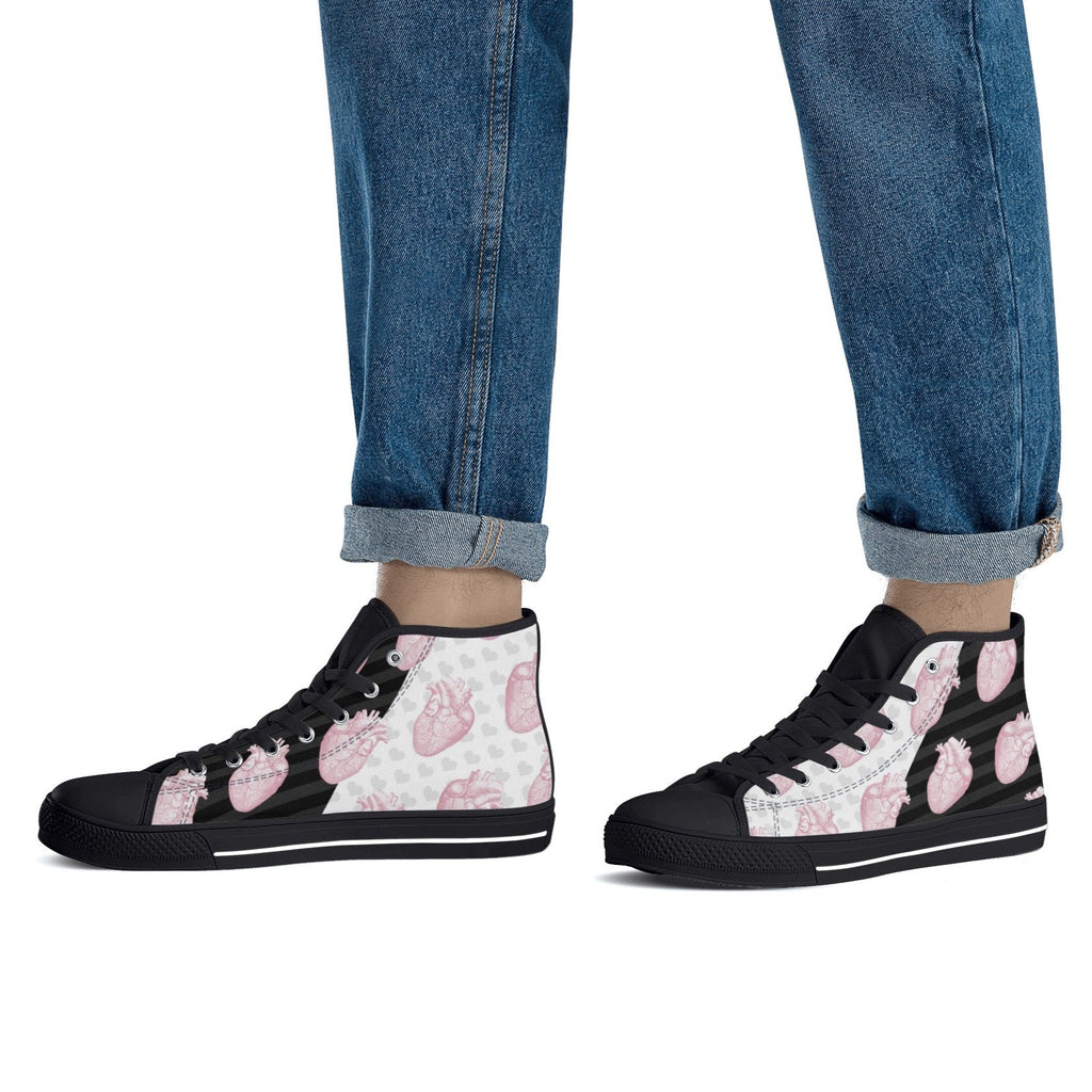 feet view of black soles Pastel goth Halloween high-top shoes with skull and spooky heart design